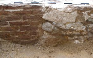 The point at which the brick  wall transitions into a stone wall.